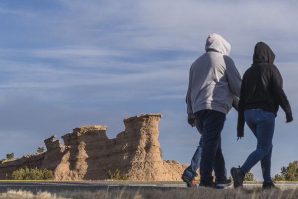 Pilgrims passing the typical rock formation between Nambe and Chimayo