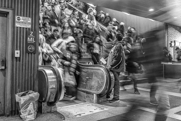 Rush hour at NYC's Penn Station, and a man who hopes to have something to eat tonight.