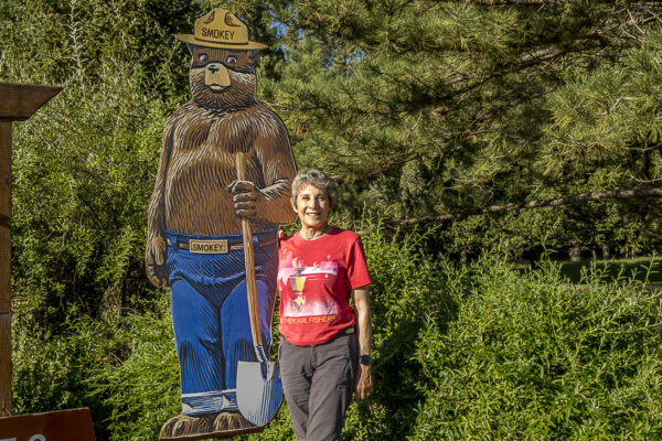 Smokey Bear is posing with Cindy